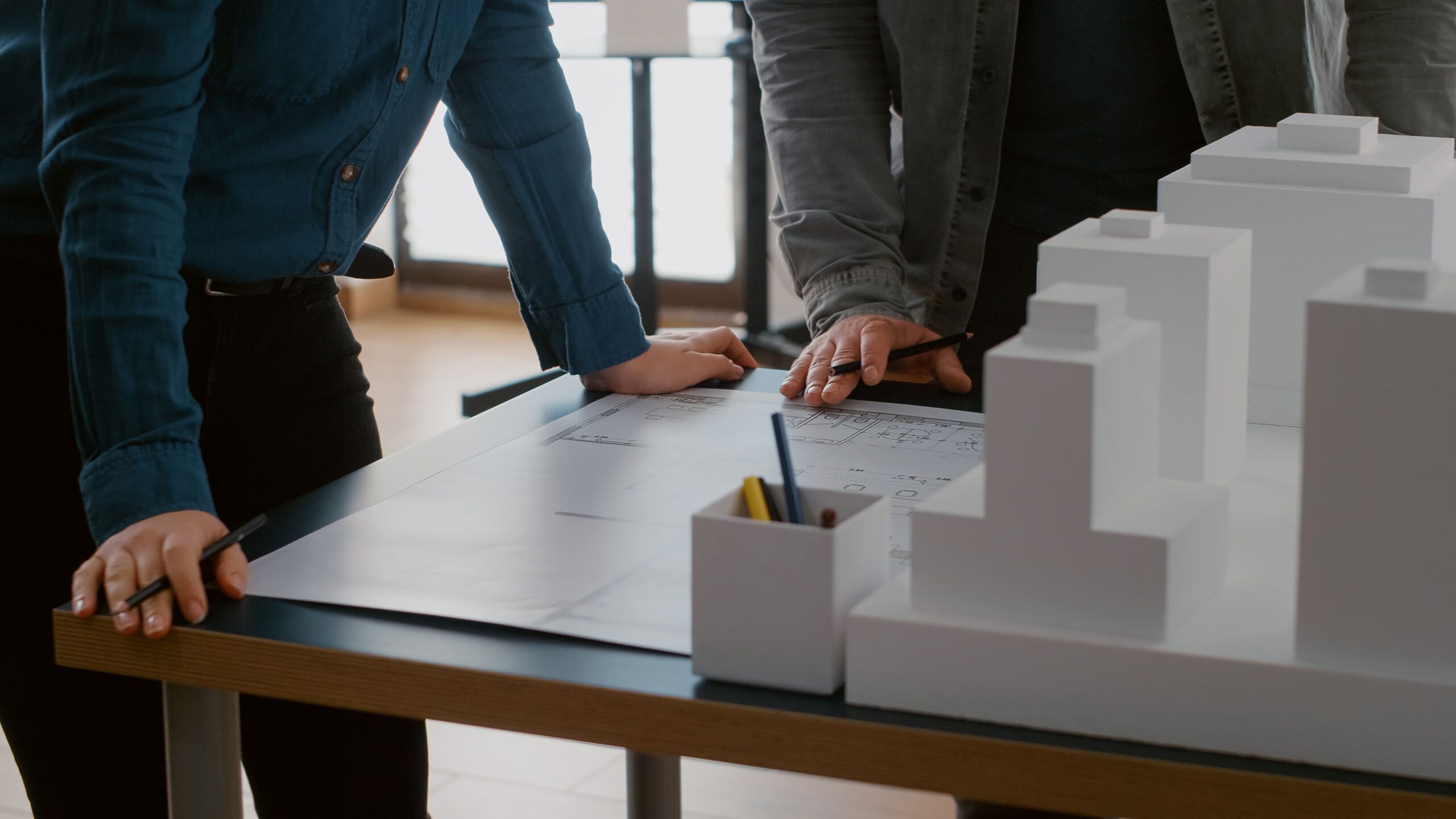 https://www.dstonearchitecture.com/wp-content/uploads/2026/10/close-up-colleagues-working-urban-design-with-blueprints-building-model-team-people-doing-teamwork-construction-layout-designing-architectural-development-project-1-scaled.jpg