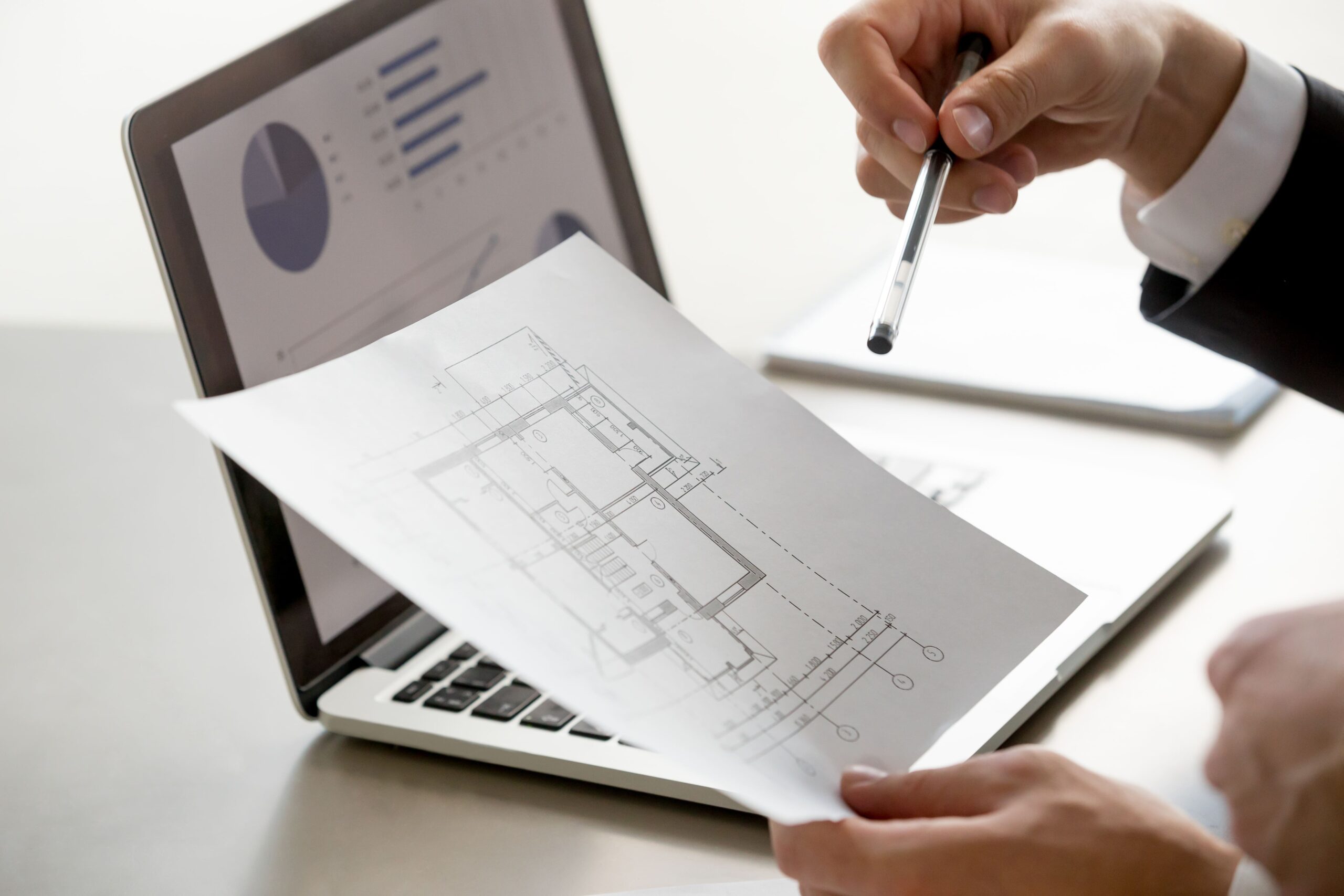https://www.dstonearchitecture.com/wp-content/uploads/2026/10/male-hand-holding-project-plan-statistics-screen-close-up-1-scaled.jpg